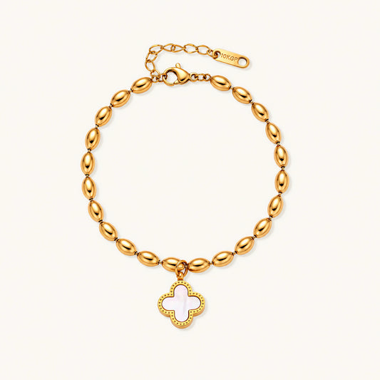 18K gold-plated oval bead bracelet with a four-leaf clover charm in mother-of-pearl or black enamel, adjustable lobster clasp, on white background.